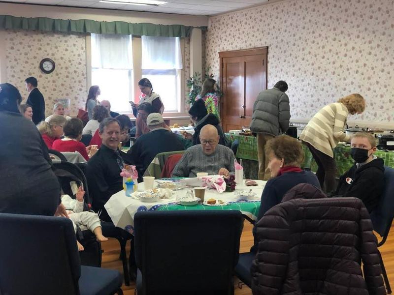 Members sharing a meal in the fellowship hall